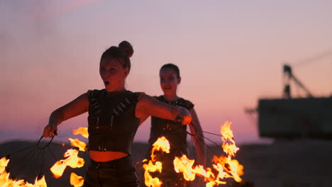 Fire-dancers-against-sunset.-A-young-woman-poses-with-her-fire-hoop-against-the-sunset-during-her-dance-performance